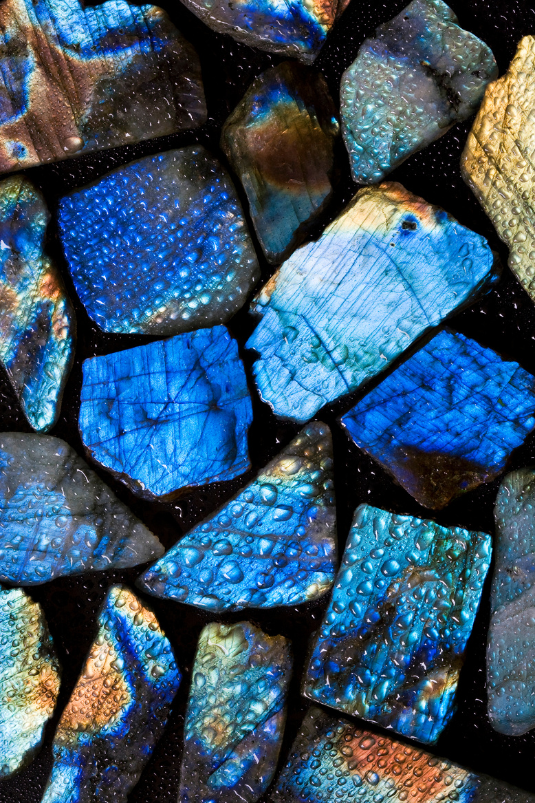 Wet colorful labradorite gem stones.